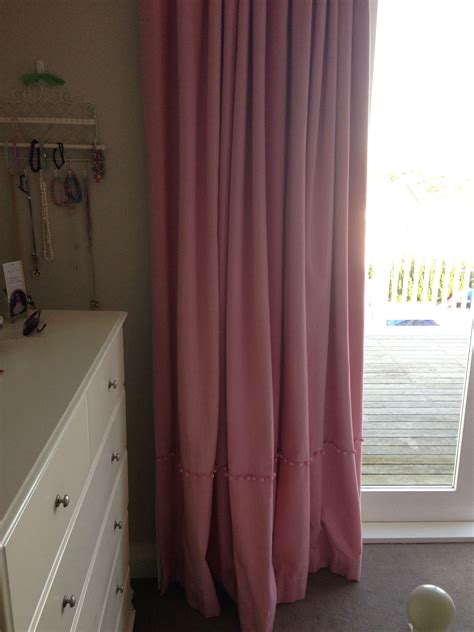 pink curtains with pom poms